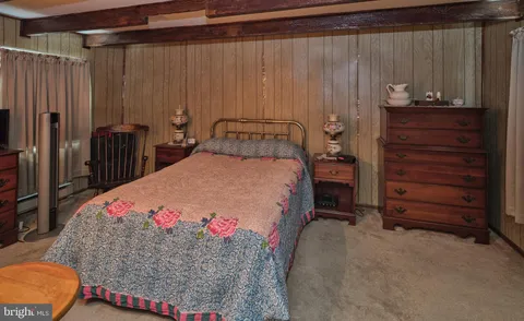 a bathroom with a granite countertop sink a toilet and shower