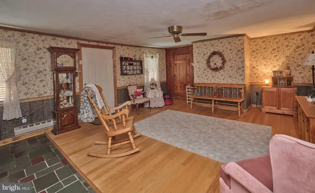 a living room with furniture a flat screen tv and a table