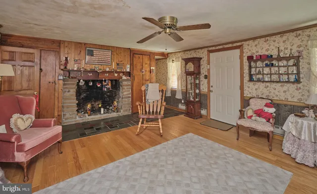 a living room with furniture a rug and a window