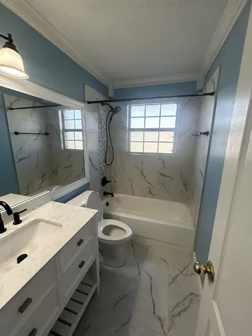 a bathroom with a sink mirror toilet and bathtub