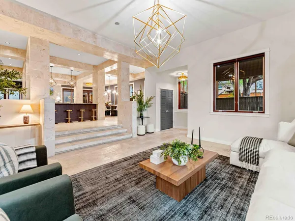 a living room with furniture and a chandelier