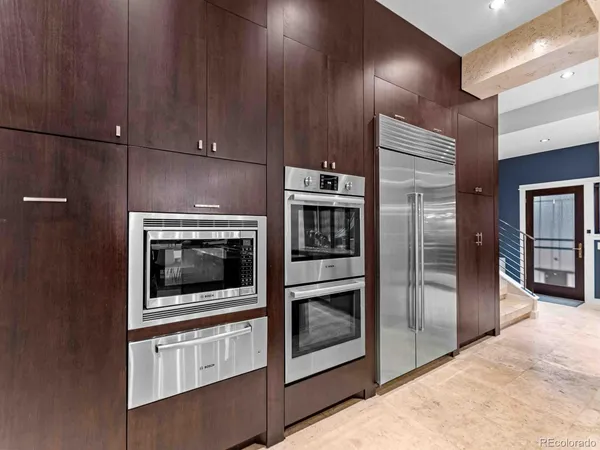 a kitchen with stainless steel appliances wooden cabinets and stove
