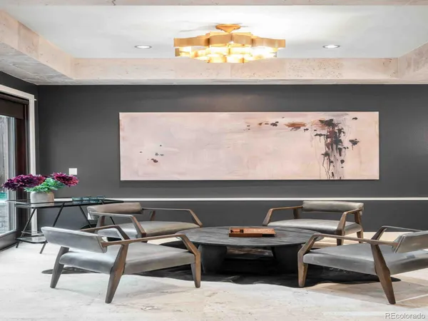 a view of a dining room with furniture and a chandelier