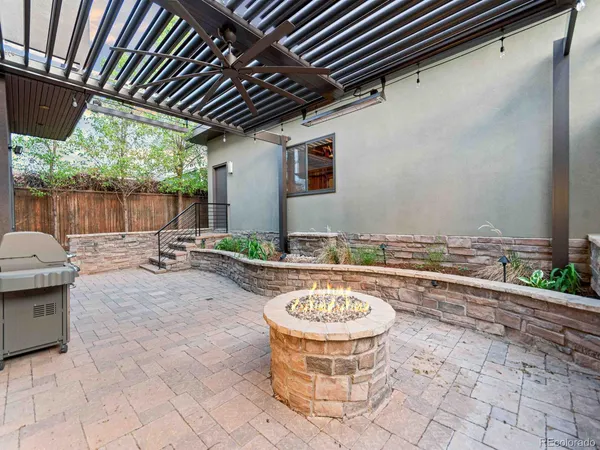 a backyard of a house with fountain table and chairs
