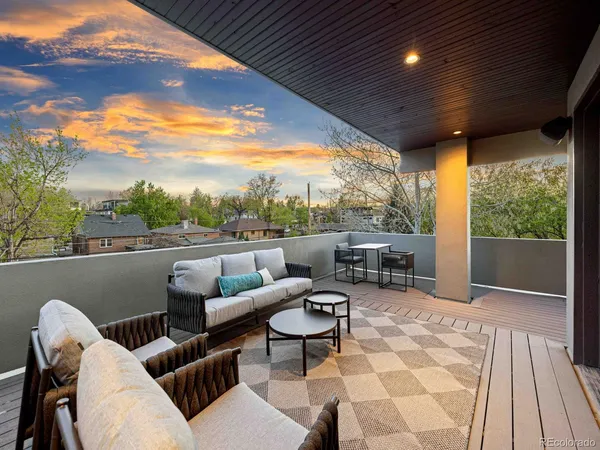 a balcony with furniture and a table