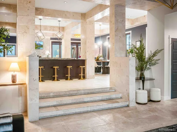 a view of a lobby with a rug and potted plants