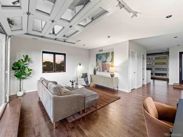 a living room with furniture and wooden floor