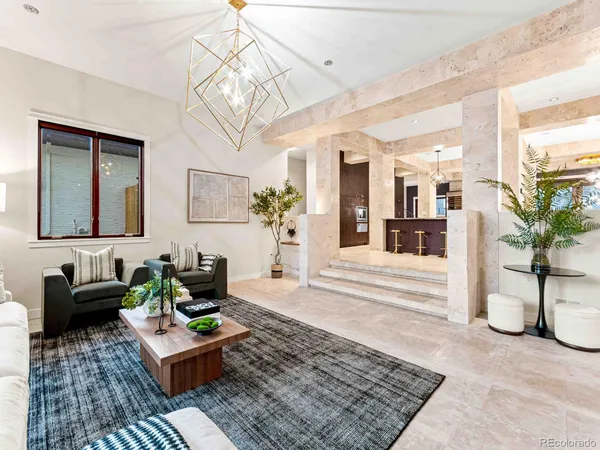a living room with furniture and a chandelier