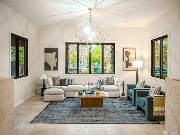a living room with furniture large window and a rug
