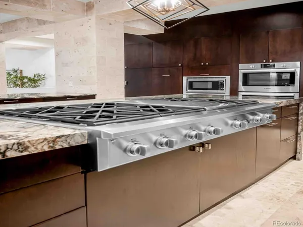 a kitchen with stainless steel appliances granite countertop a stove and a microwave