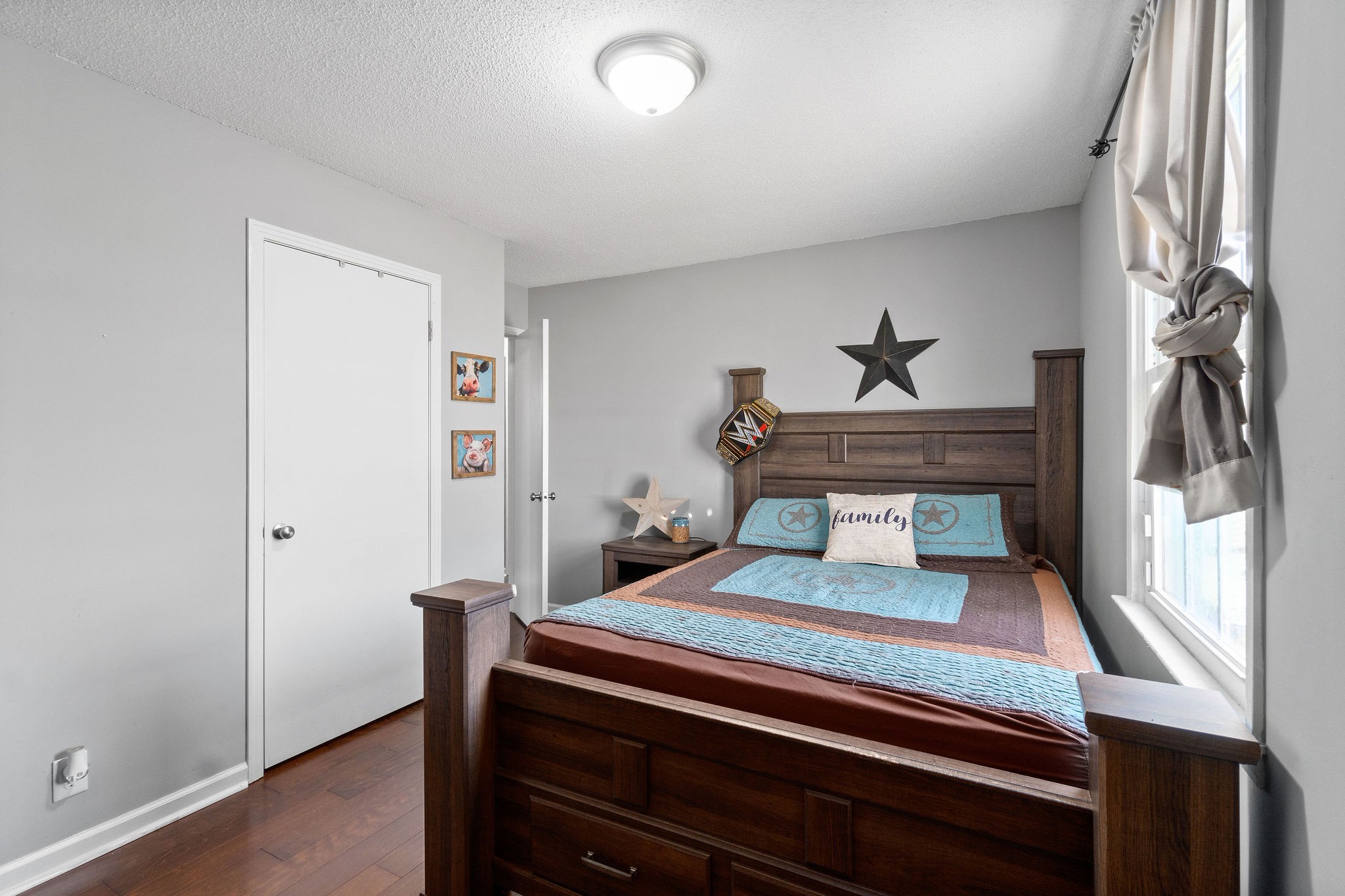 2445 Whitfield Road Clarksville, TN 37040 - Photo 18 of 29 a bedroom with a bed and a chandelier