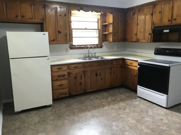 a kitchen with stainless steel appliances granite countertop a refrigerator stove a sink dishwasher and microwave