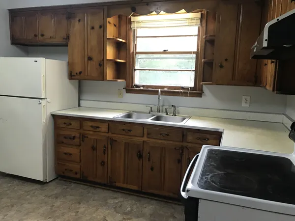 a kitchen with a sink and a refrigerator