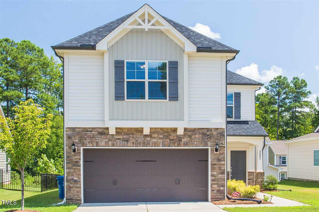 a front view of a house with a yard garage and outdoor seating