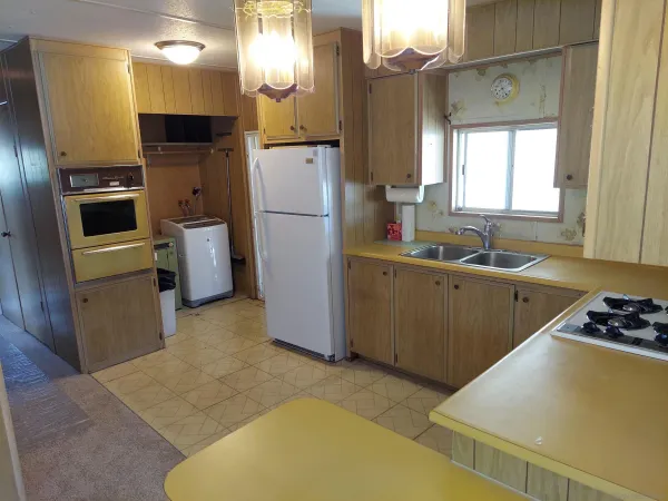 a kitchen that has a sink and a refrigerator