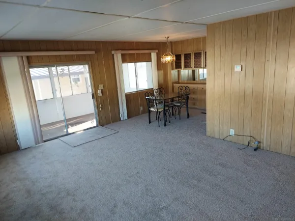 an empty room with furniture and a window
