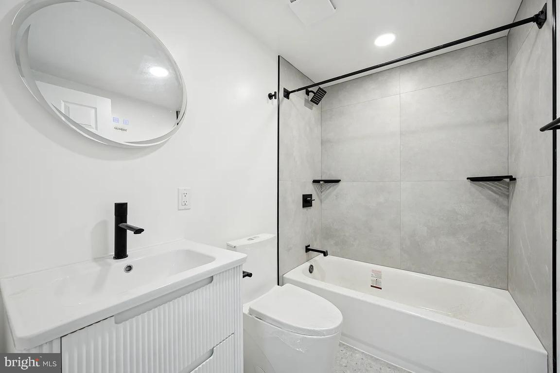 52 North 51st Street, Unit 2 Philadelphia, PA 19139 - Photo 5 of 8 a bathroom with a bathtub shower sink vanity and toilet