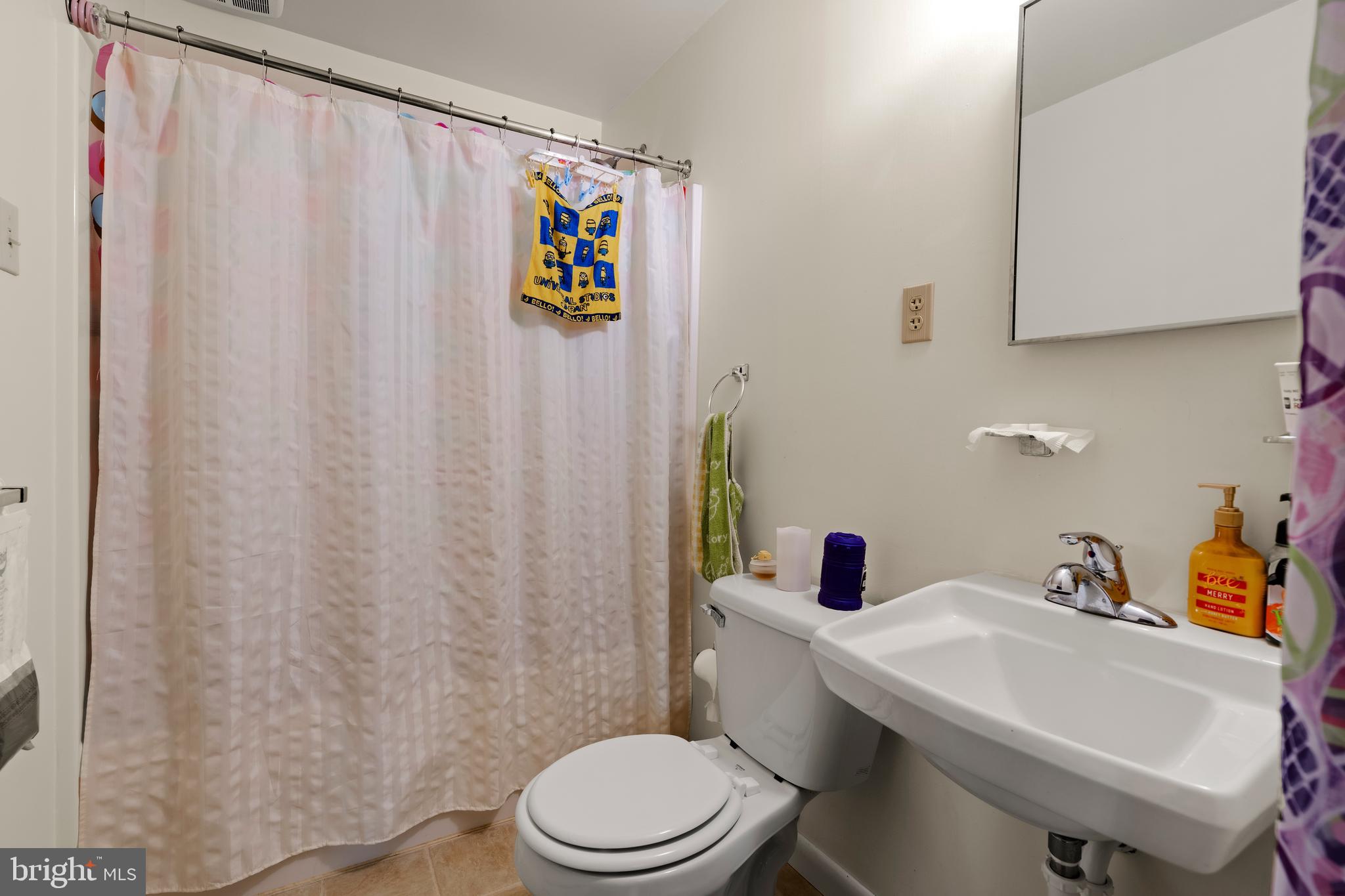 619 Millersville Road Lancaster, PA 17603 - Photo 9 of 30 a bathroom with a sink a toilet and shower curtain
