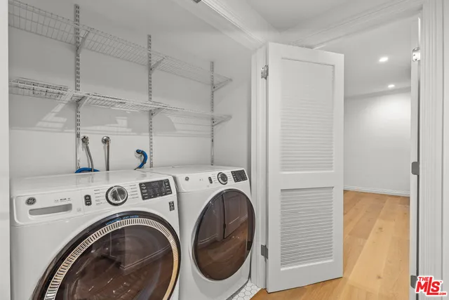 a view of storage and utility room with washer and dryer