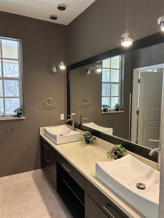3436 Primrose Way Palm Harbor, FL 34683 - Photo 14 of 16 a bathroom with a sink and a mirror