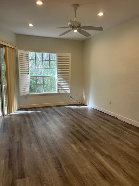 3436 Primrose Way Palm Harbor, FL 34683 - Photo 2 of 16 an empty room with wooden floor and windows