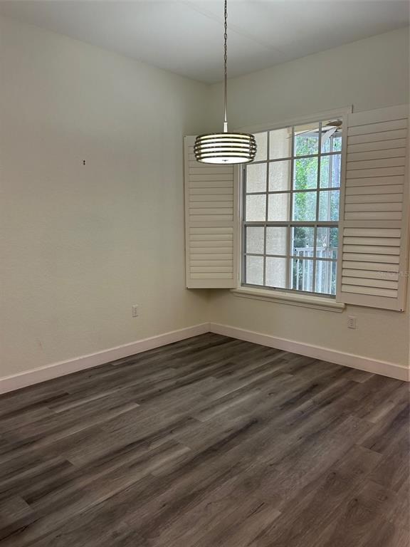 3436 Primrose Way Palm Harbor, FL 34683 - Photo 3 of 16 a view of an empty room with wooden floor and a window