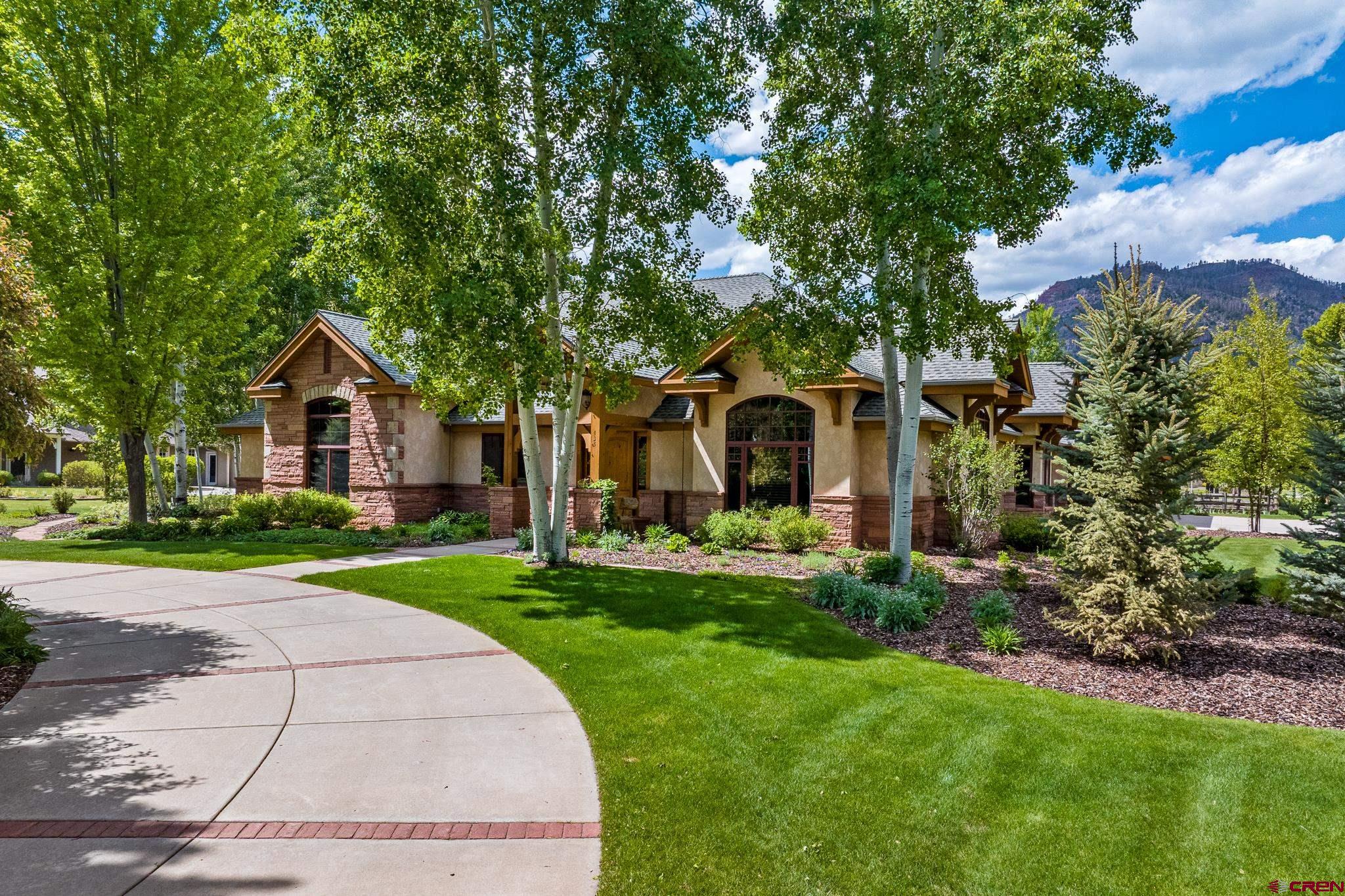 435 Red Rock Road Durango, CO 81301 - Photo 1 of 35 a front view of a house with a yard and garage
