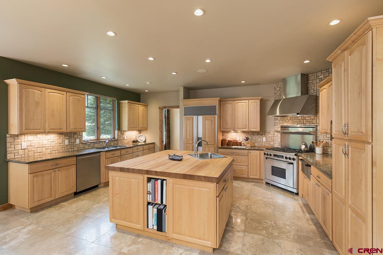 435 Red Rock Road Durango, CO 81301 - Photo 12 of 35 a kitchen with stainless steel appliances granite countertop a stove top oven a sink and dishwasher