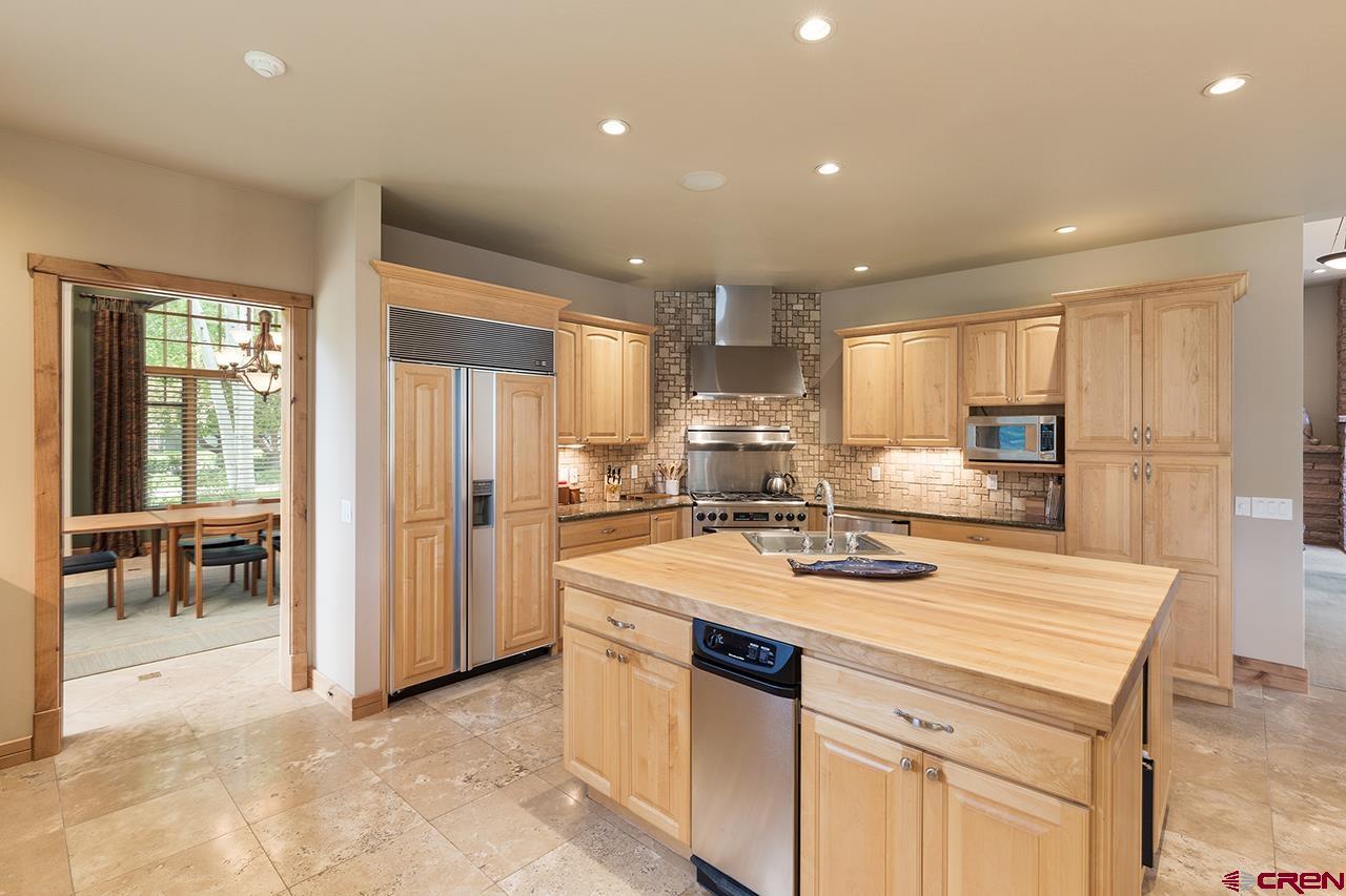 435 Red Rock Road Durango, CO 81301 - Photo 13 of 35 a kitchen with a sink a stove a refrigerator and white cabinets