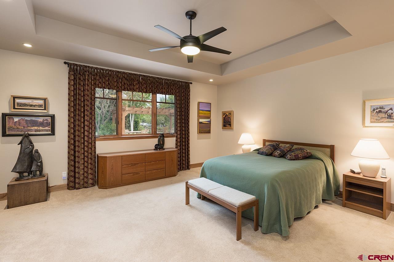 435 Red Rock Road Durango, CO 81301 - Photo 17 of 35 a bedroom with a bed and a large window with the outer view