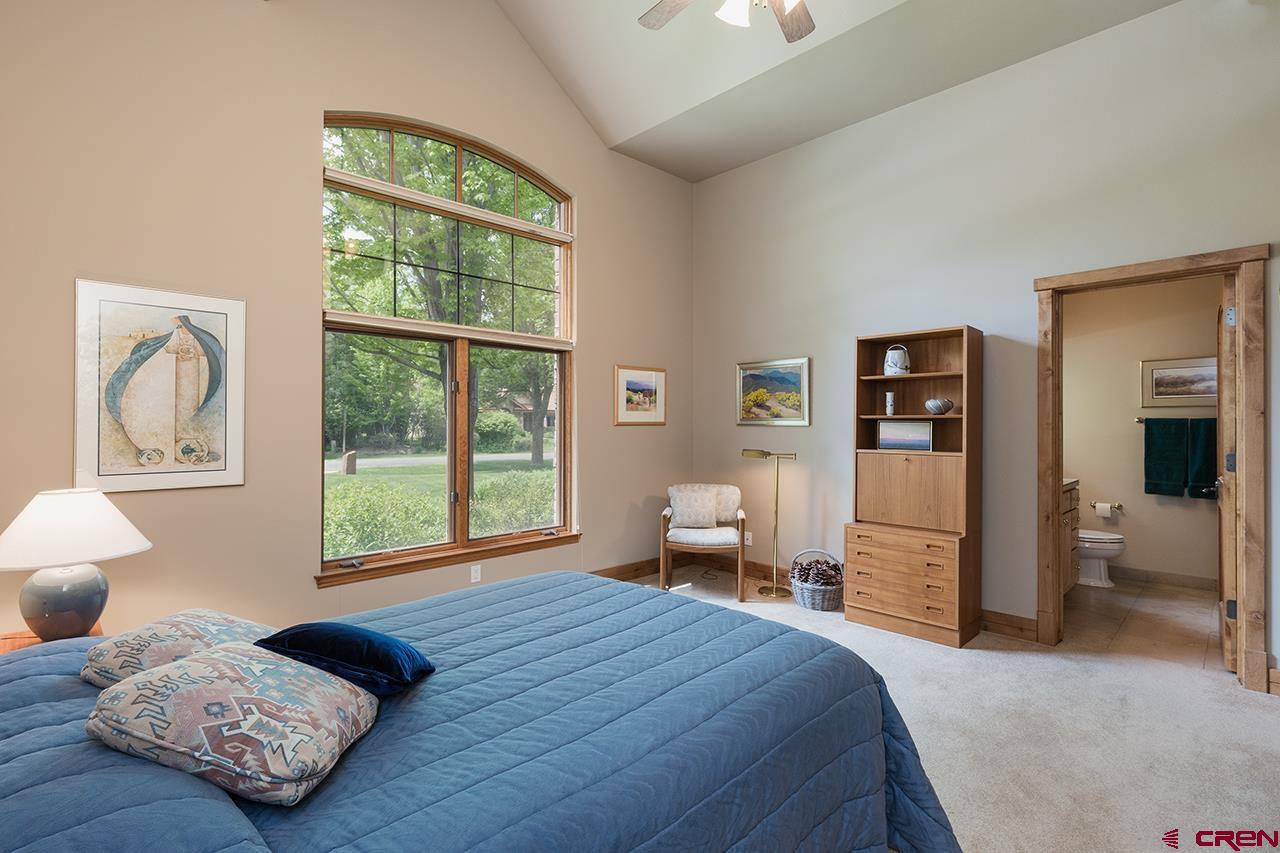 435 Red Rock Road Durango, CO 81301 - Photo 24 of 35 a bedroom with a bed and wooden floor