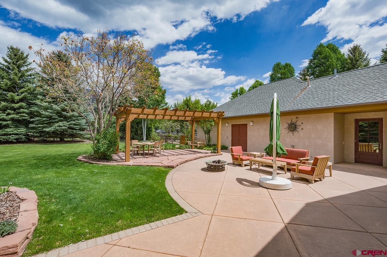 435 Red Rock Road Durango, CO 81301 - Photo 31 of 35 a view of a house with backyard sitting area and garden