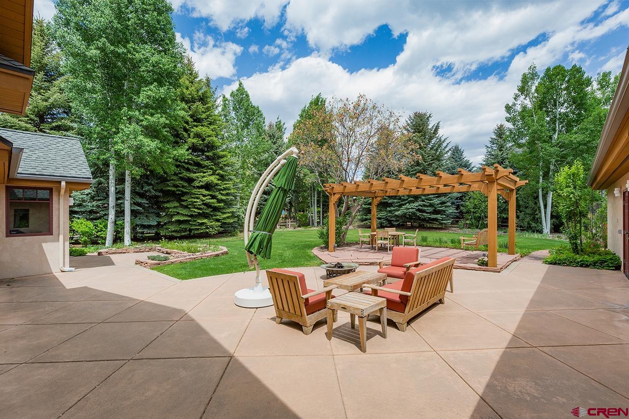 435 Red Rock Road Durango, CO 81301 - Photo 32 of 35 a view of a patio with a table and chairs under an umbrella