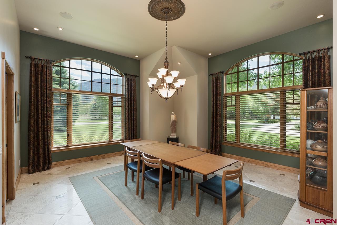 435 Red Rock Road Durango, CO 81301 - Photo 8 of 35 a dining room with chandelier and wooden floor