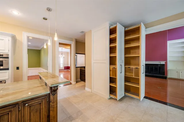 a view of kitchen with furniture and electronic appliances