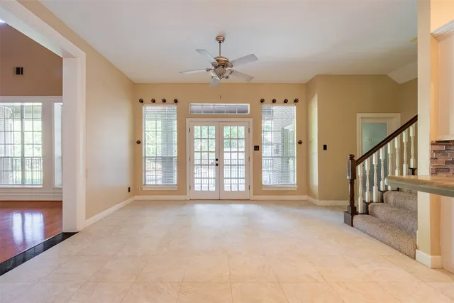 a kitchen with granite countertop white cabinets white appliances and a large window