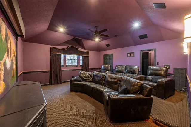 a room with furniture projector and screen