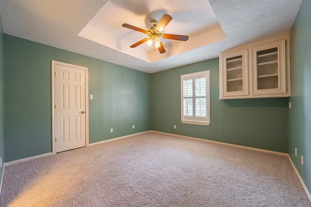 a bathroom with a granite countertop sink a toilet and bathtub