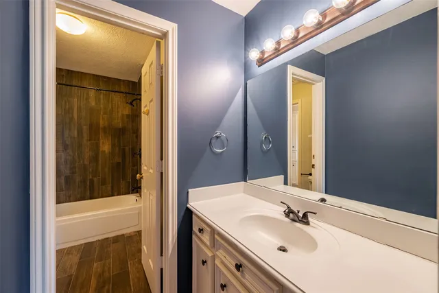 a view of a house with a yard and large tree