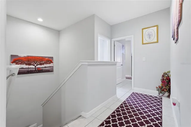 a bedroom with a bed table and a chandelier
