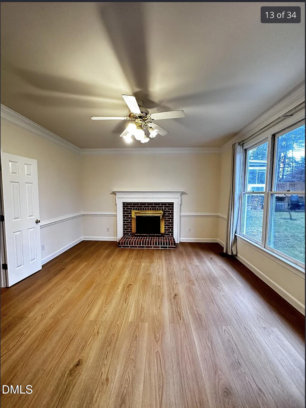 214 Cobble Ridge Drive Chapel Hill, NC 27516 - Photo 14 of 34 a view of empty room with wooden floor and fireplace