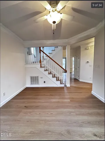 a view of entryway and hall with wooden floor