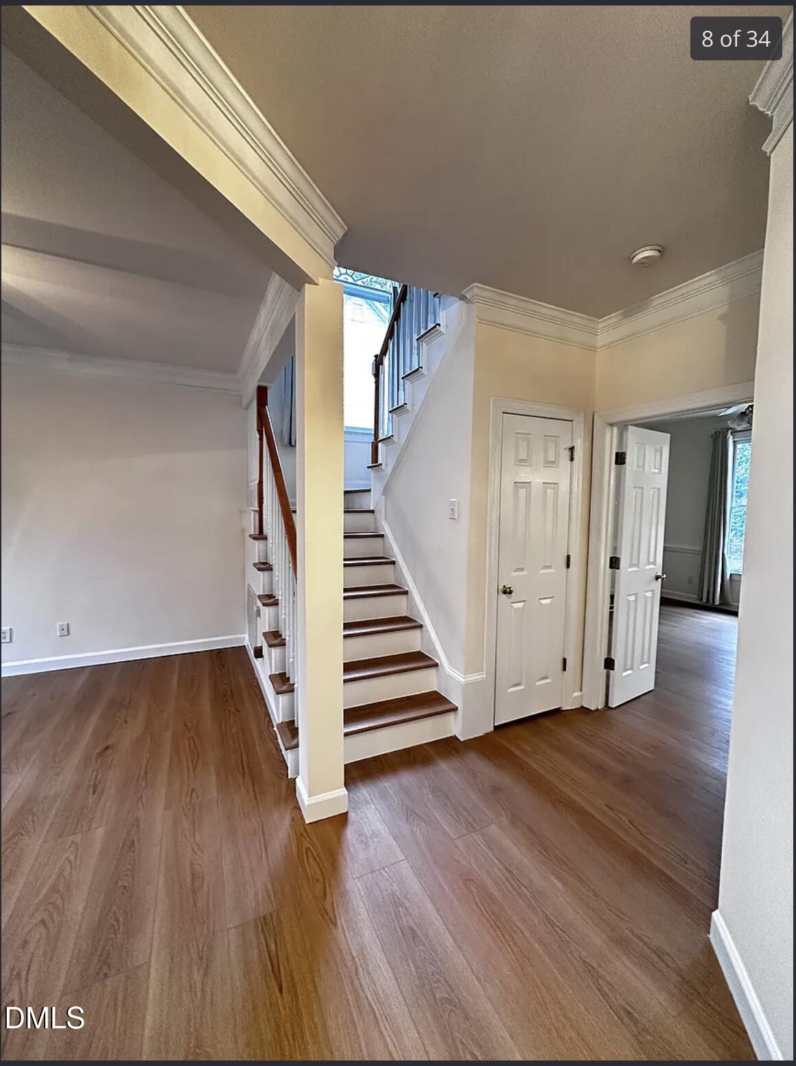 214 Cobble Ridge Drive Chapel Hill, NC 27516 - Photo 18 of 34 a view of a hallway with wooden floors and stairs