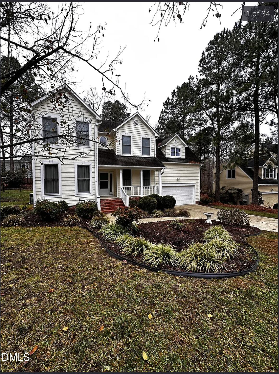 214 Cobble Ridge Drive Chapel Hill, NC 27516 - Photo 2 of 34 a view of a white house next to a yard with a large tree