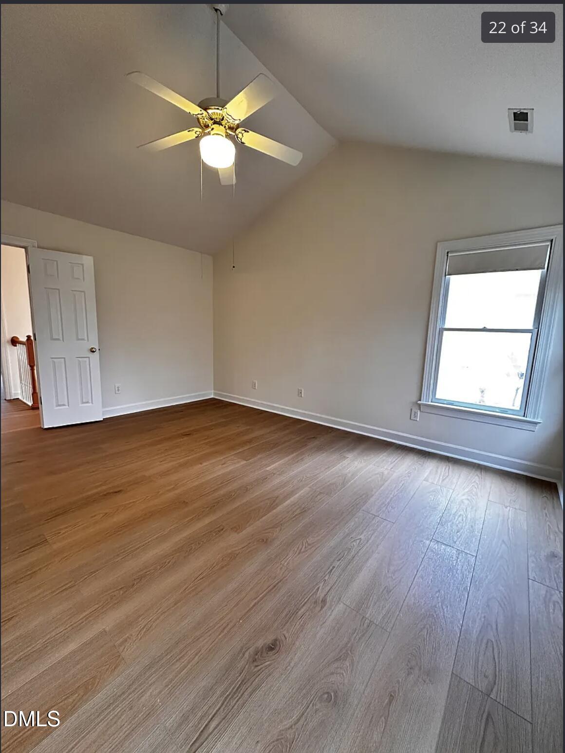 214 Cobble Ridge Drive Chapel Hill, NC 27516 - Photo 21 of 34 an empty room with wooden floor and windows