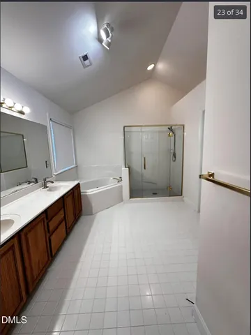 a large bathroom with a double vanity sink mirror and toilet