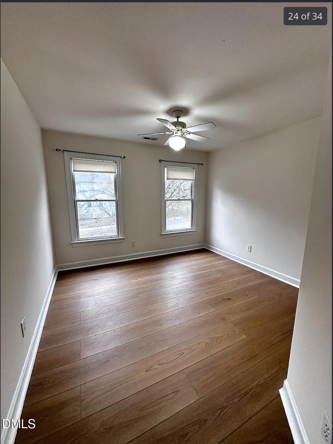 214 Cobble Ridge Drive Chapel Hill, NC 27516 - Photo 23 of 34 an empty room with windows and ceiling fan