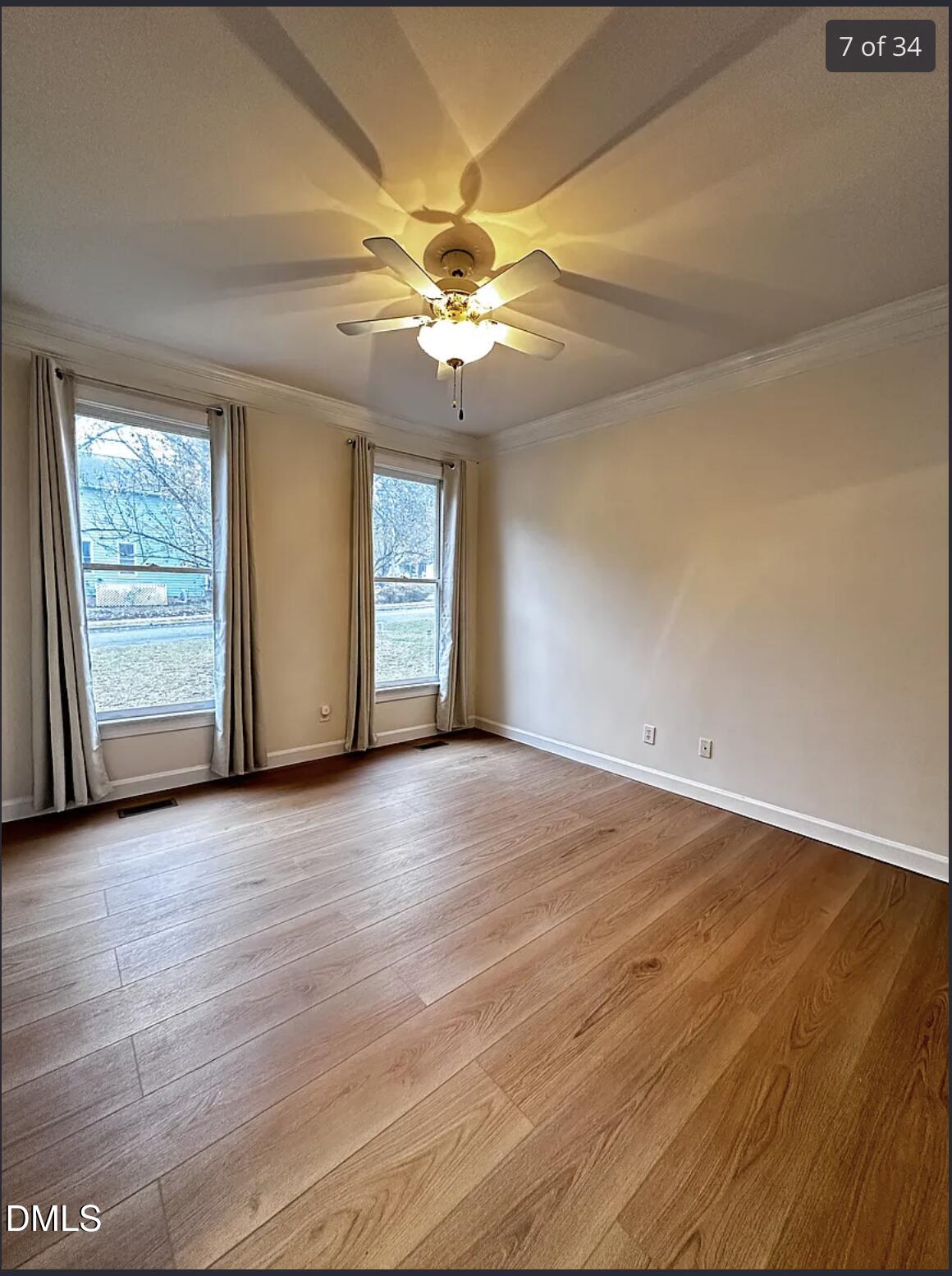 214 Cobble Ridge Drive Chapel Hill, NC 27516 - Photo 25 of 34 an empty room with windows and fan