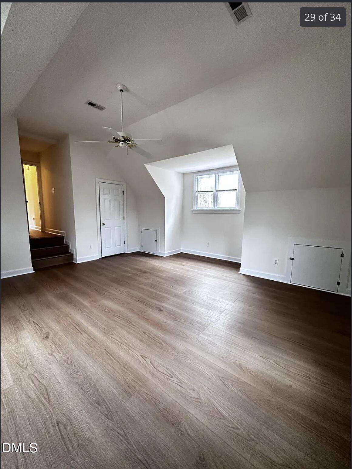 214 Cobble Ridge Drive Chapel Hill, NC 27516 - Photo 26 of 34 an empty room with wooden floor and windows
