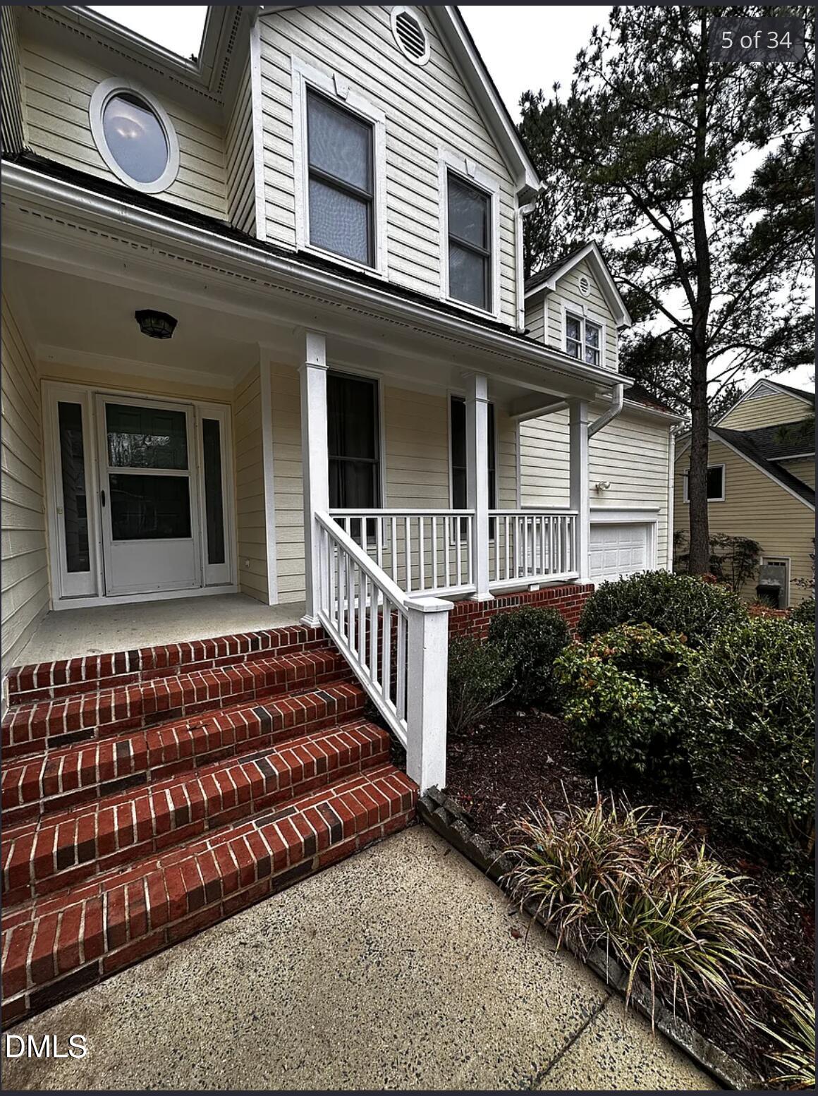 214 Cobble Ridge Drive Chapel Hill, NC 27516 - Photo 5 of 34 a view of a house with a small yard and wooden fence and large trees